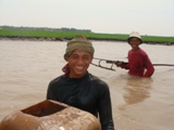 'Rake' fishing in the canals during dry season